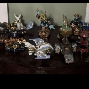 Skylanders random characters and 2 SuperChargers vehicles in boxes.